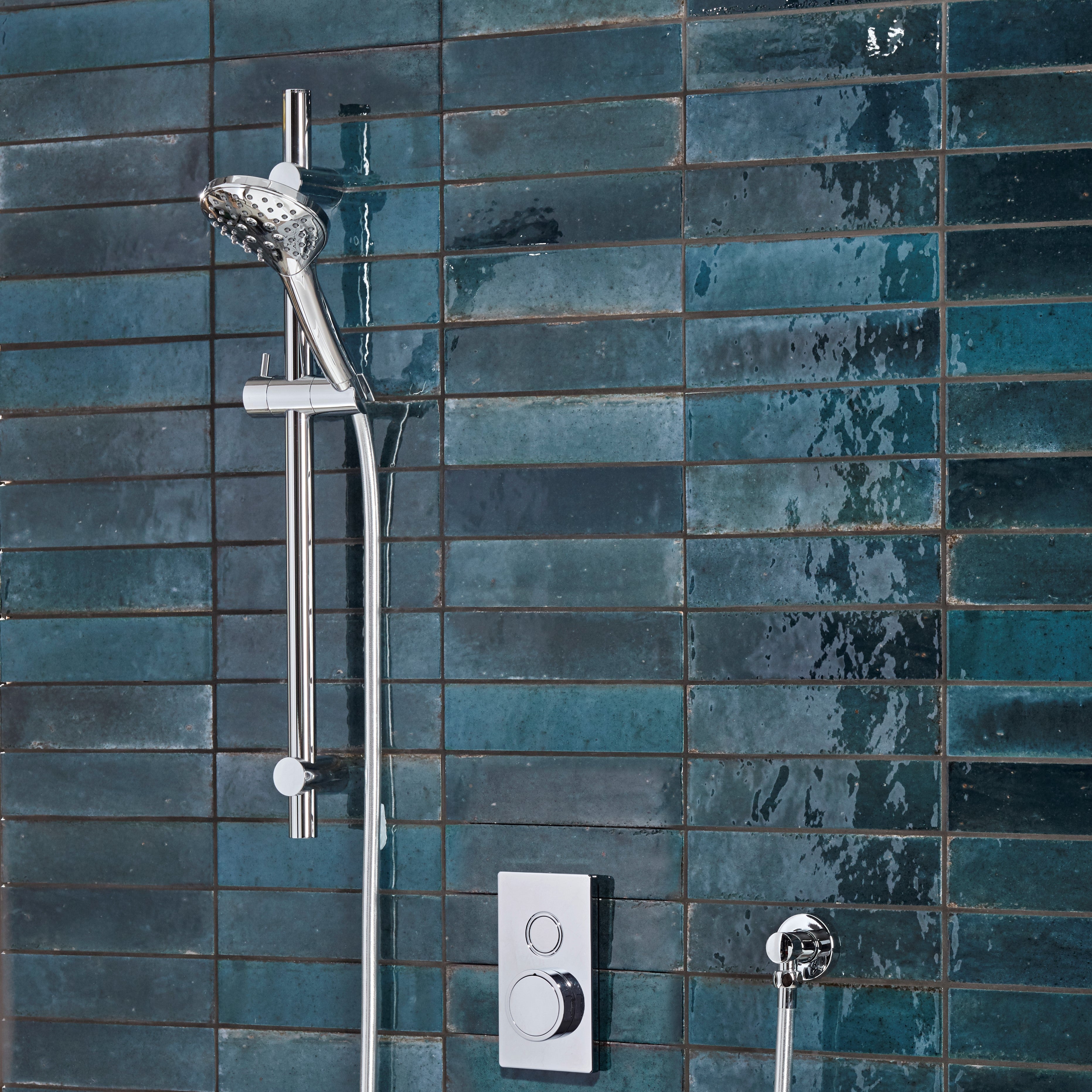 Tavistock Axiom Single Function Push Button Shower System With Riser Kit - Chrome against blue tiling SAX2316