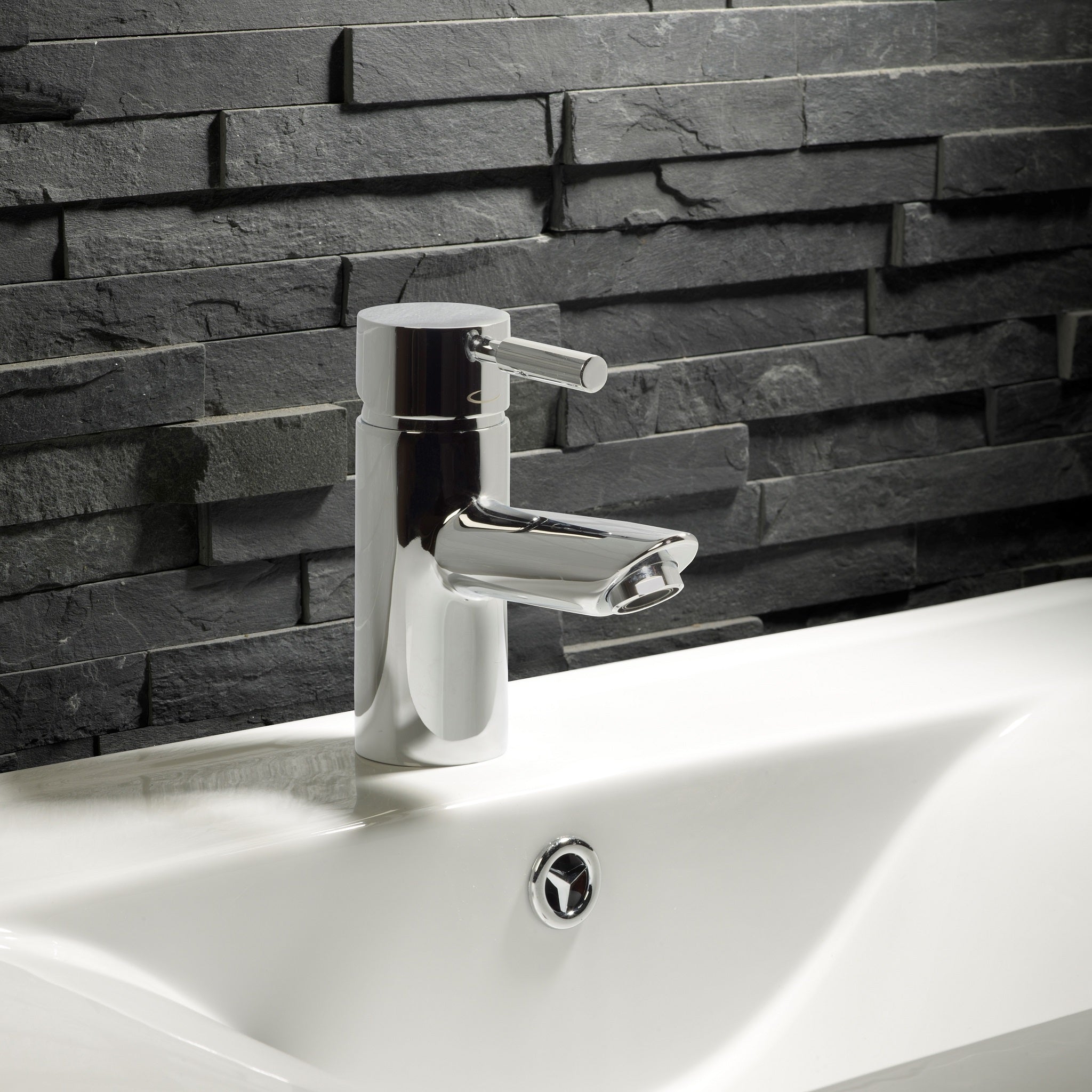 Tavistock Kinetic Basin Mixer Without Popup - Chrome against dark grey stone close up view TKN12
