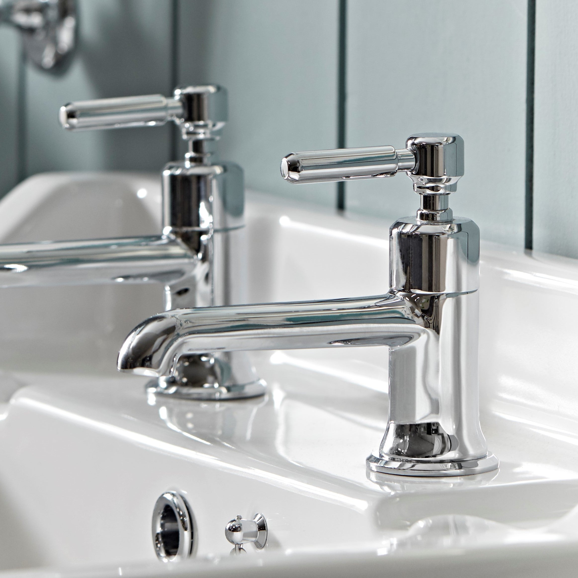 Tavistock Marston Deck Mounted Bath Filler - Chrome close up view highlighting the basins with a blurred background TMS32