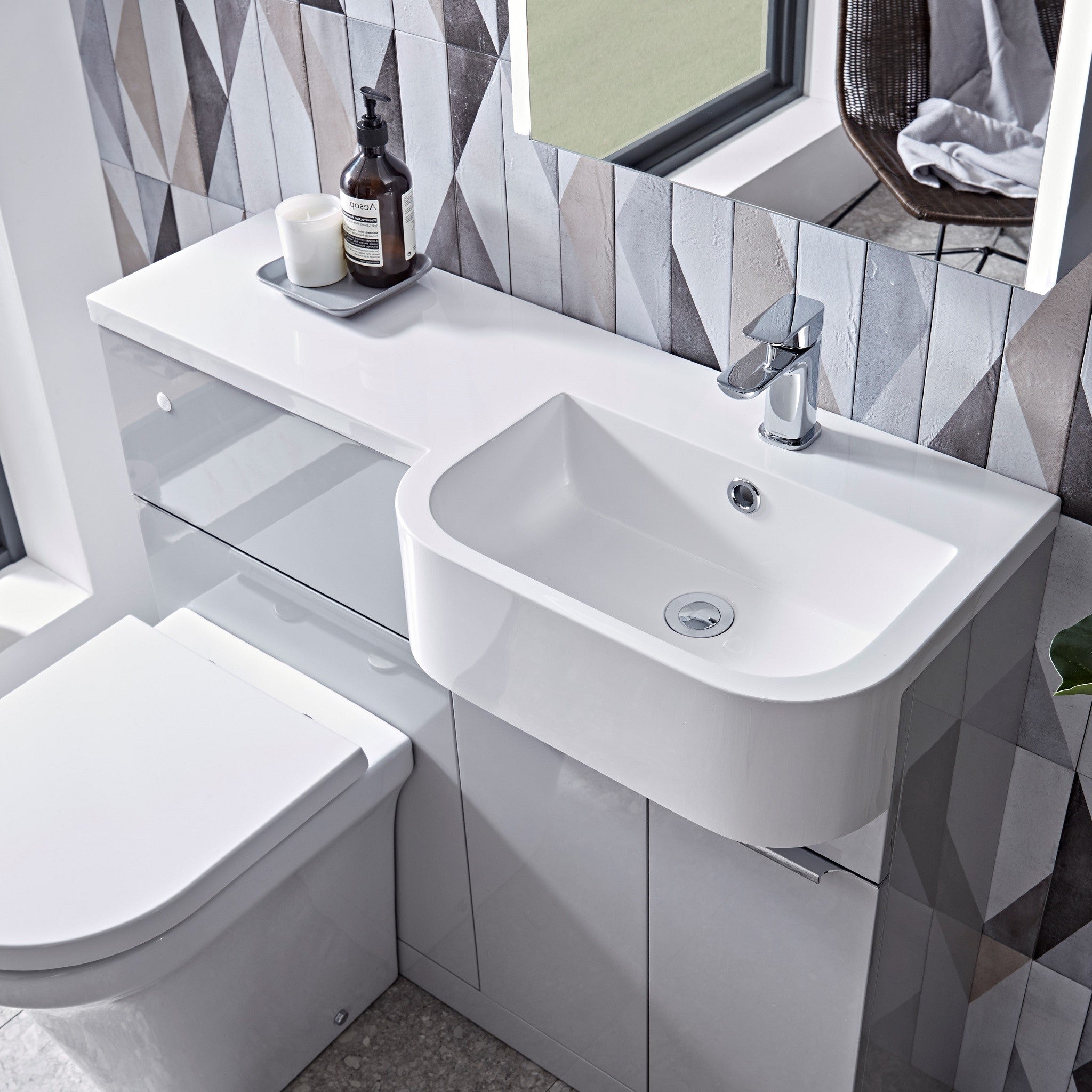 Tavistock Match 1000mm Combination Unit - Gloss Light Grey (L or R Hand) unit against wooden wallpaper design underneath a mirror MATRG