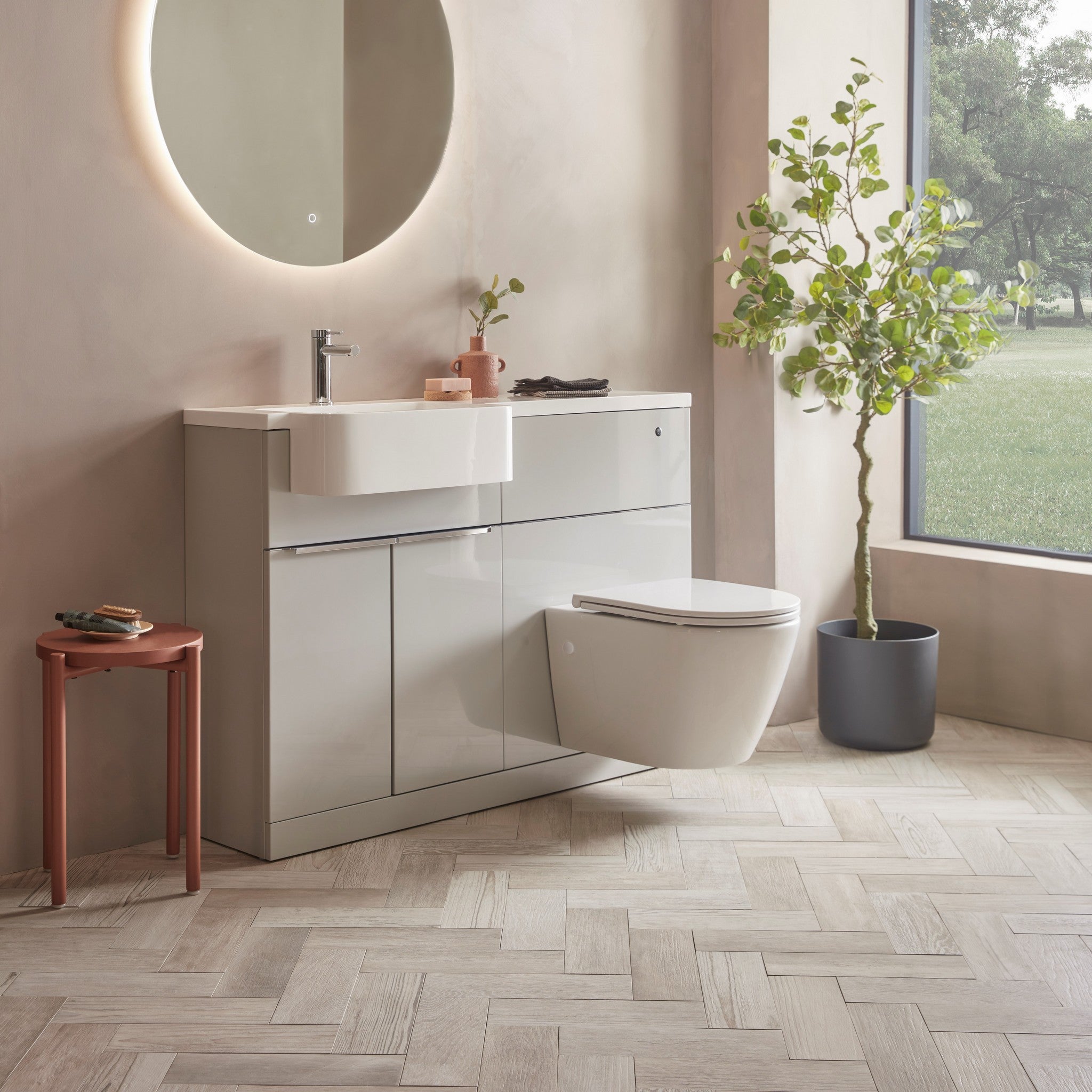 Tavistock Match 1200mm Combination Unit - Gloss Light Grey (L or R Hand) against pal painted wall underneath a light up mirror MAT12LG