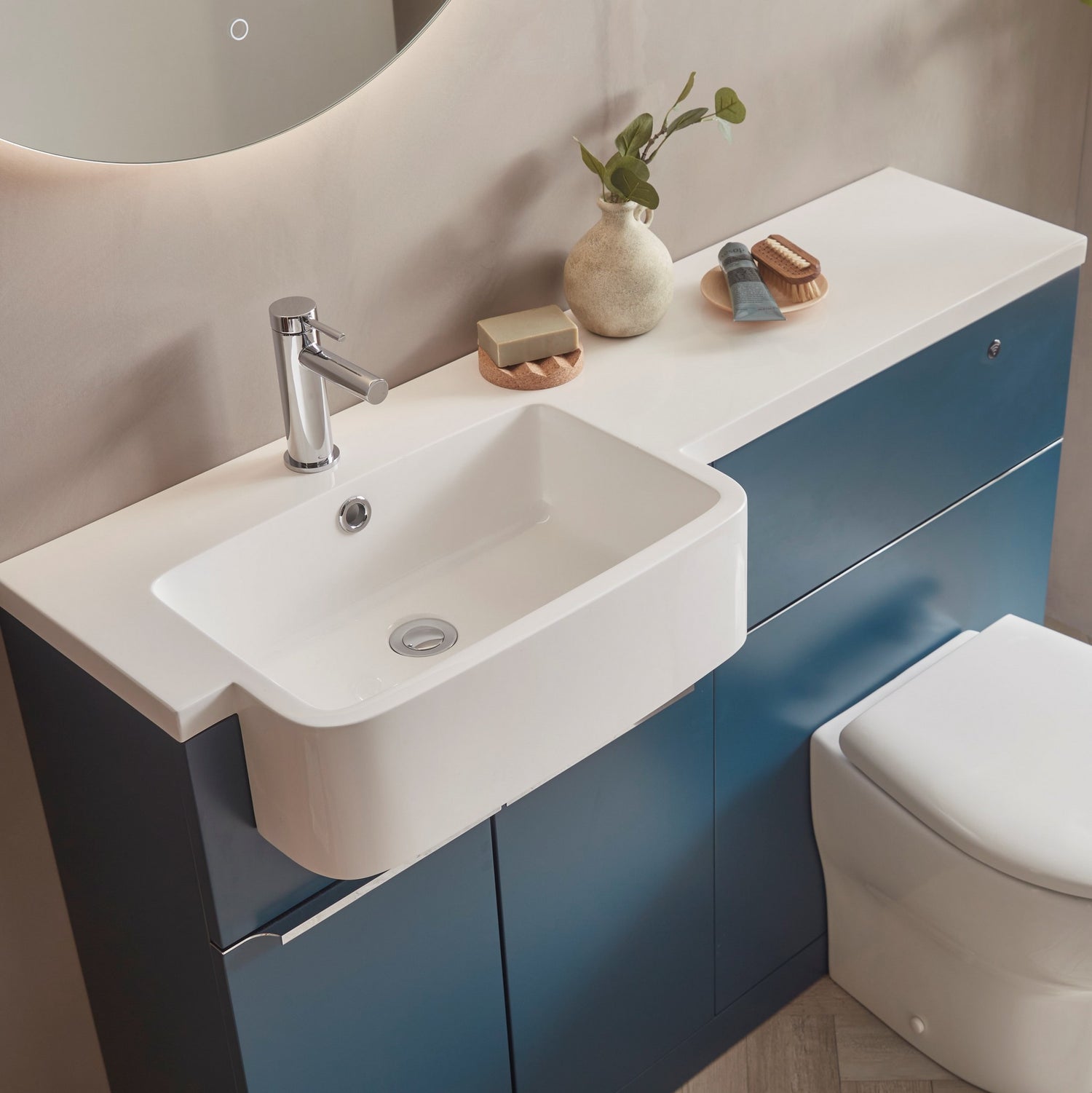 Tavistock Match 1200mm Combination Unit - Oxford Blue (L or R Hand) against pal painted wall underneath a light up mirror MAT12LOB