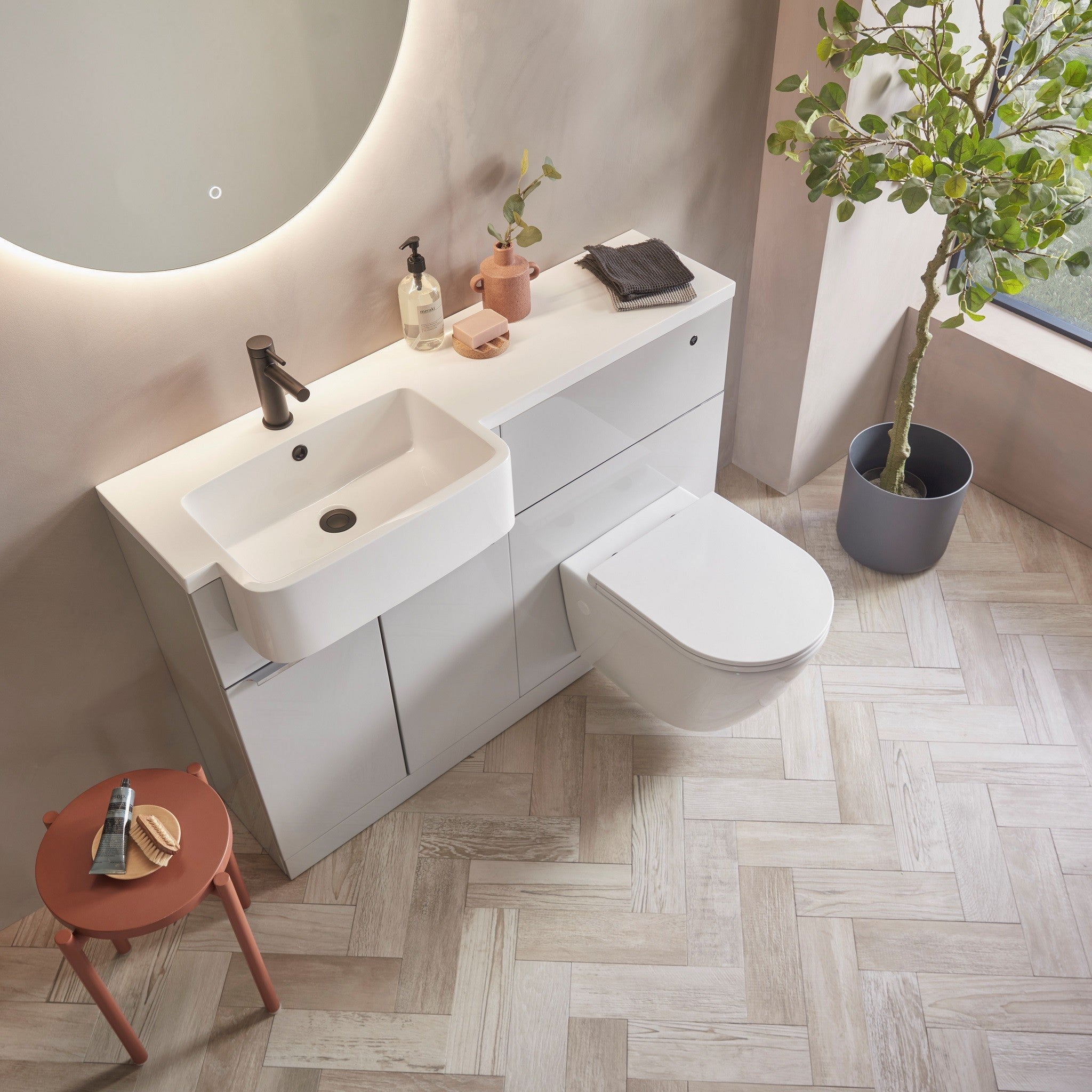 Tavistock Match 1200mm Combination Unit - Gloss Light Grey (L or R Hand) against pal painted wall underneath a light up mirror MAT12LG