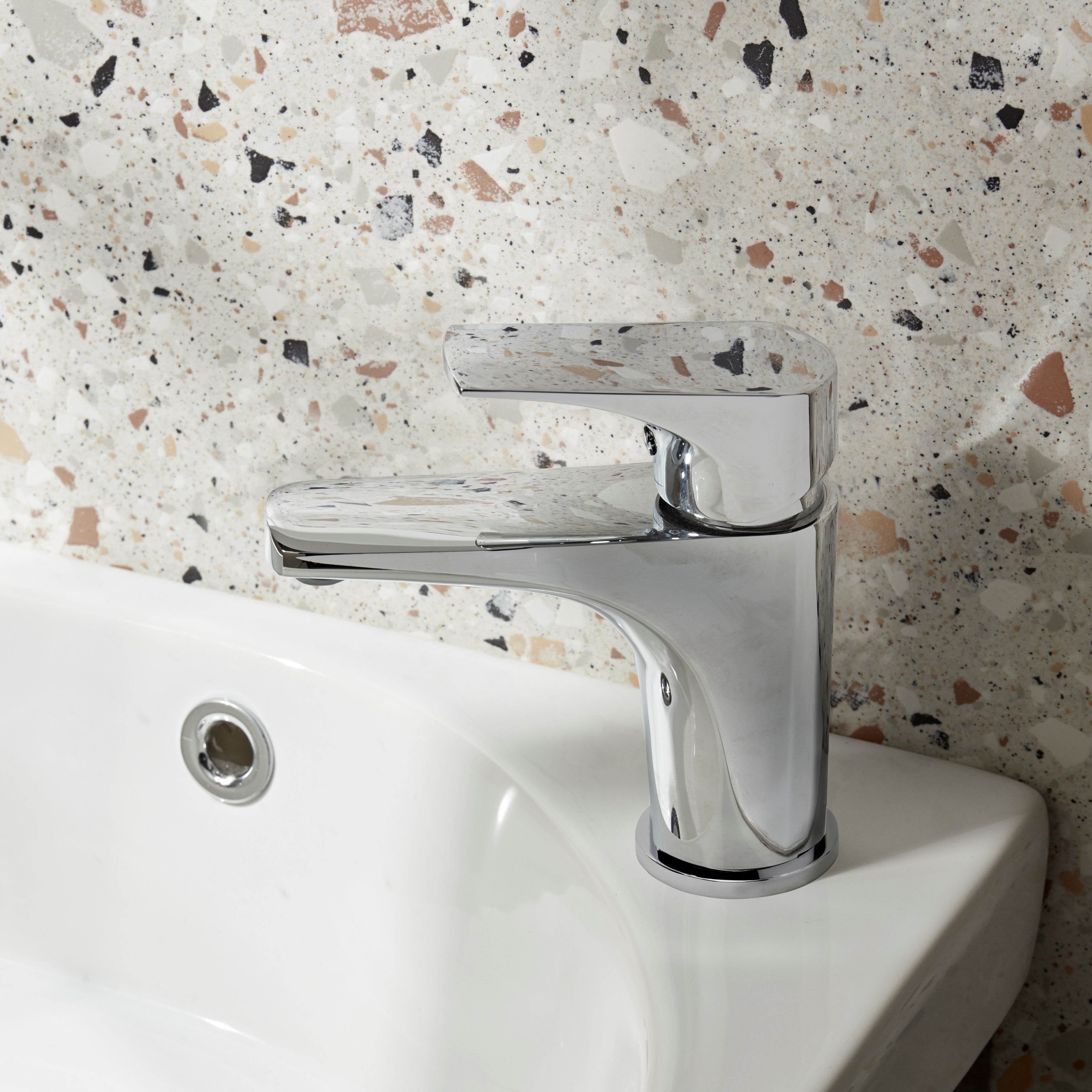 Tavistock Strike Basin Mixer With Click Waste - Chrome close up view of basin colour stone wall against the unit TSE11