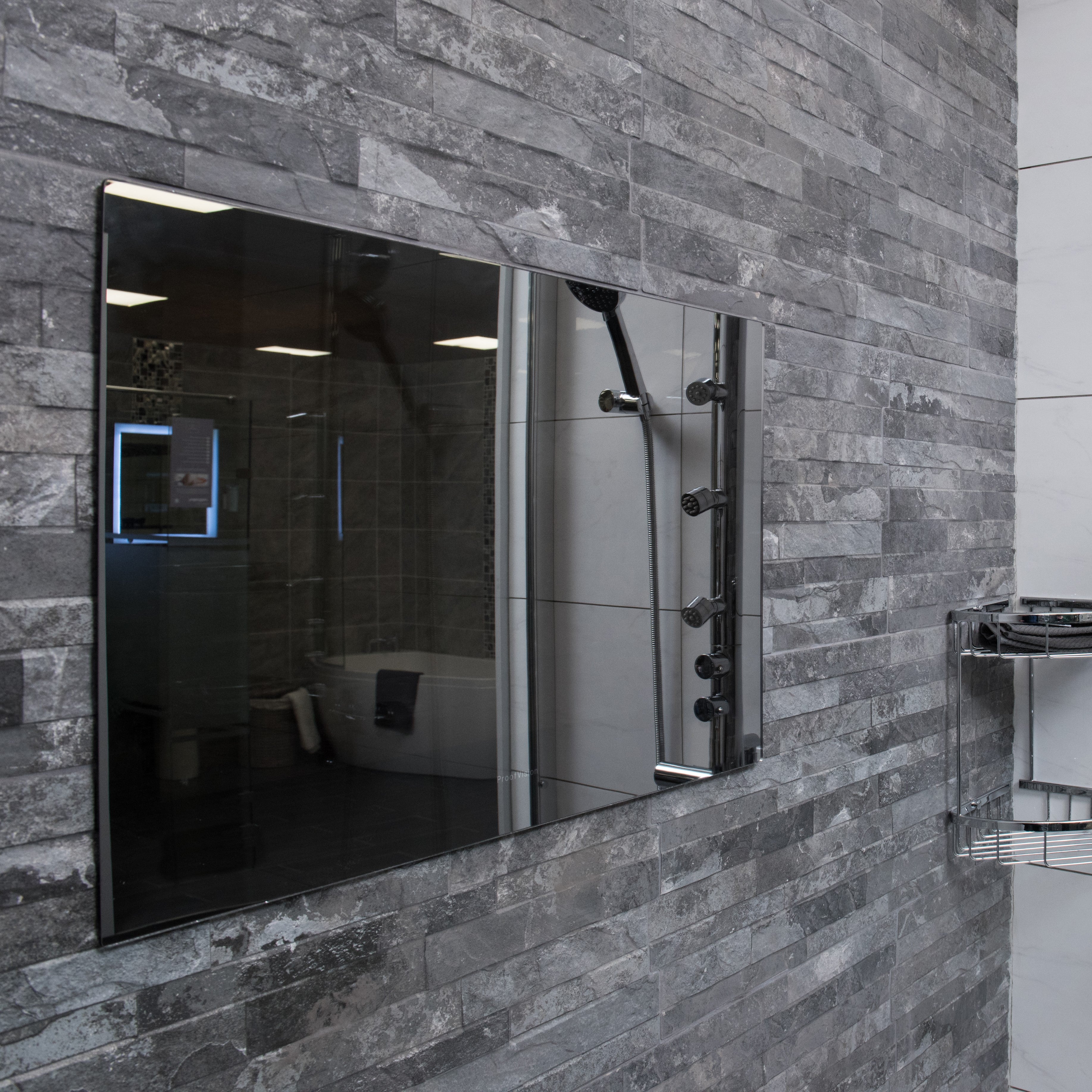 ProofVision 24inch Premium Bathroom Smart TV against stoned wall in grey tones PV24MF-A