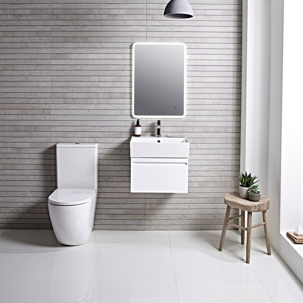 Tavistock Forum 500mm Wall Mounted Unit & Basin - Various Colours wide view wooden wall next to mirror above the basin/unit and a toilet on the left side FR50WW