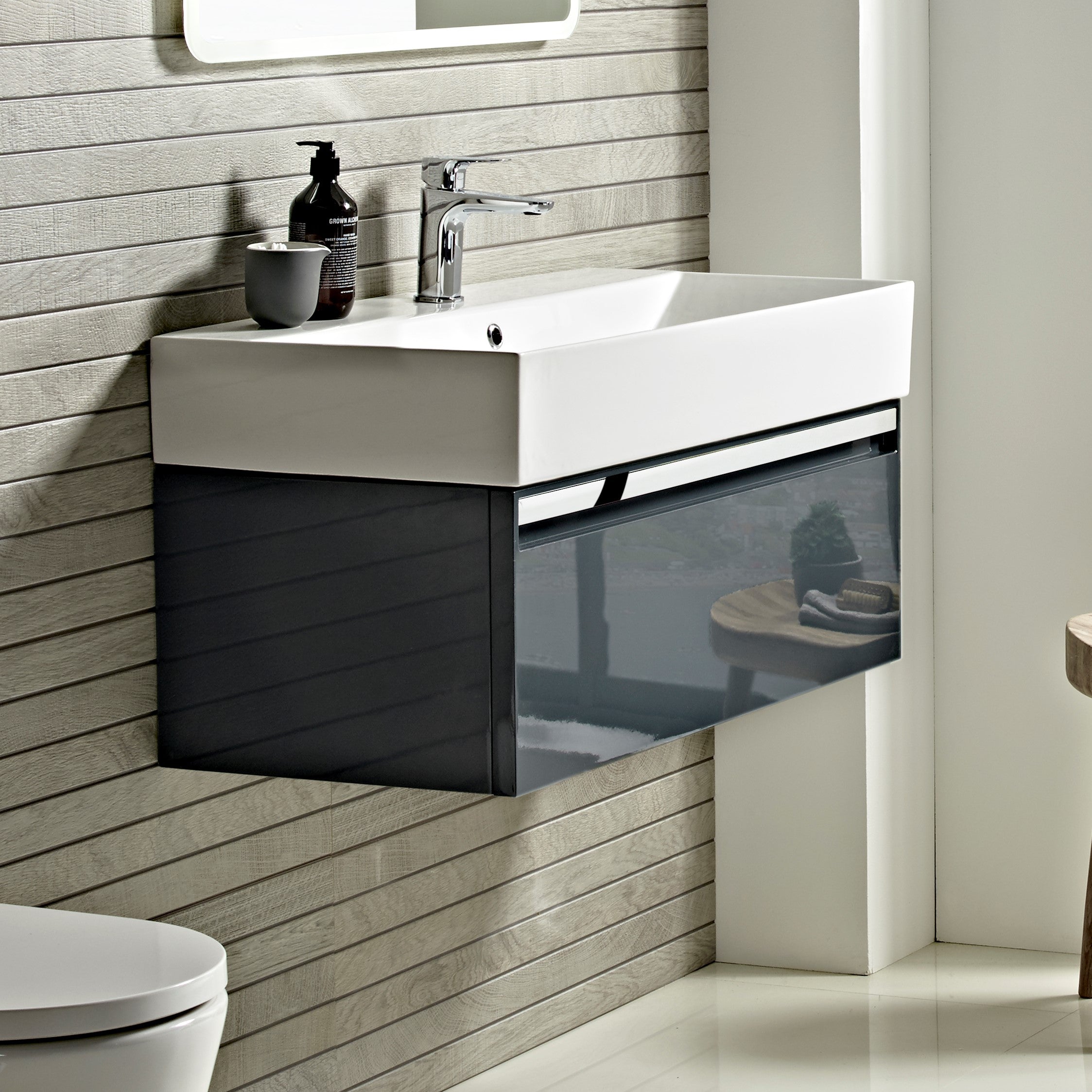 Tavistock Forum 600mm Wall Mounted Unit & Basin - Various Colours against wooden wall underneath a mirror FR90WOB