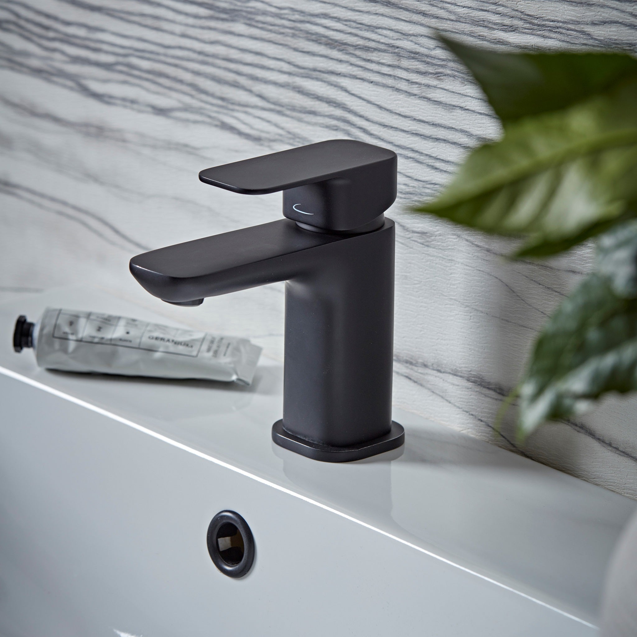Tavistock Haze Mini Basin Mixer With Click Waste against wooden wallpaper design THZ6103