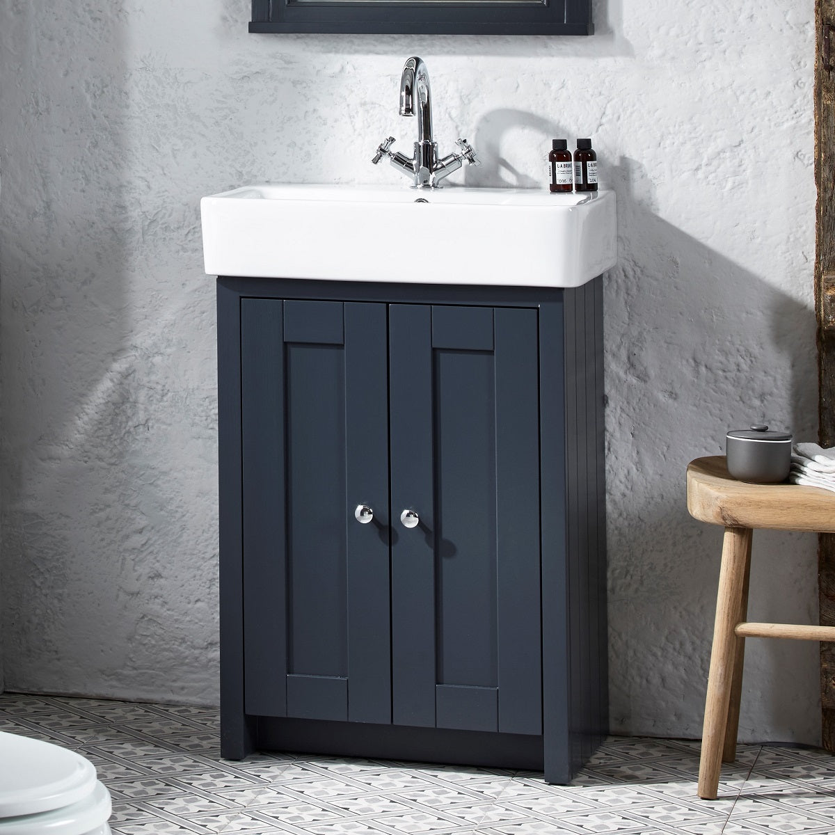 Tavistock Lansdown 575mm Freestanding Unit & Basin - Various Colours against a white stone wall underneath a mirror  LAN550B.MB