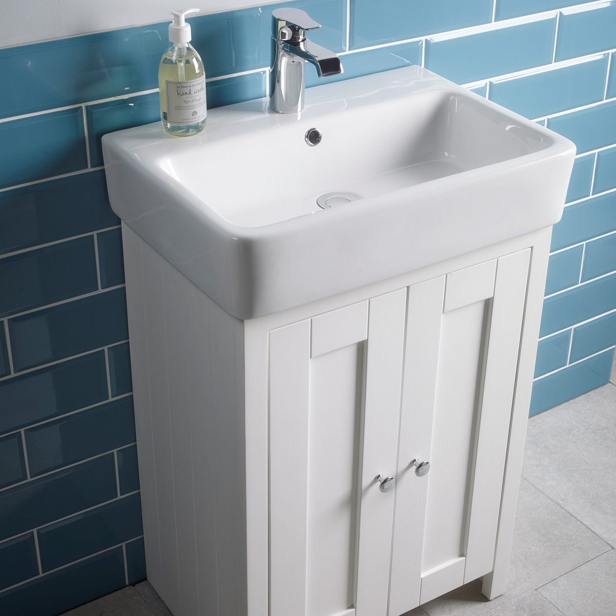 Tavistock Lansdown 575mm Freestanding Unit & Basin - Various Colours close up view against light blue tiling LAN550B.LW