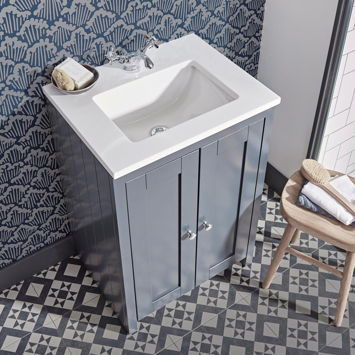 Tavistock Lansdown 600mm Freestanding Unit & Undersunk Basin - Various Colours  against white and blue wallpaper with the basin/unit above tiled flooring LAN600US.PG