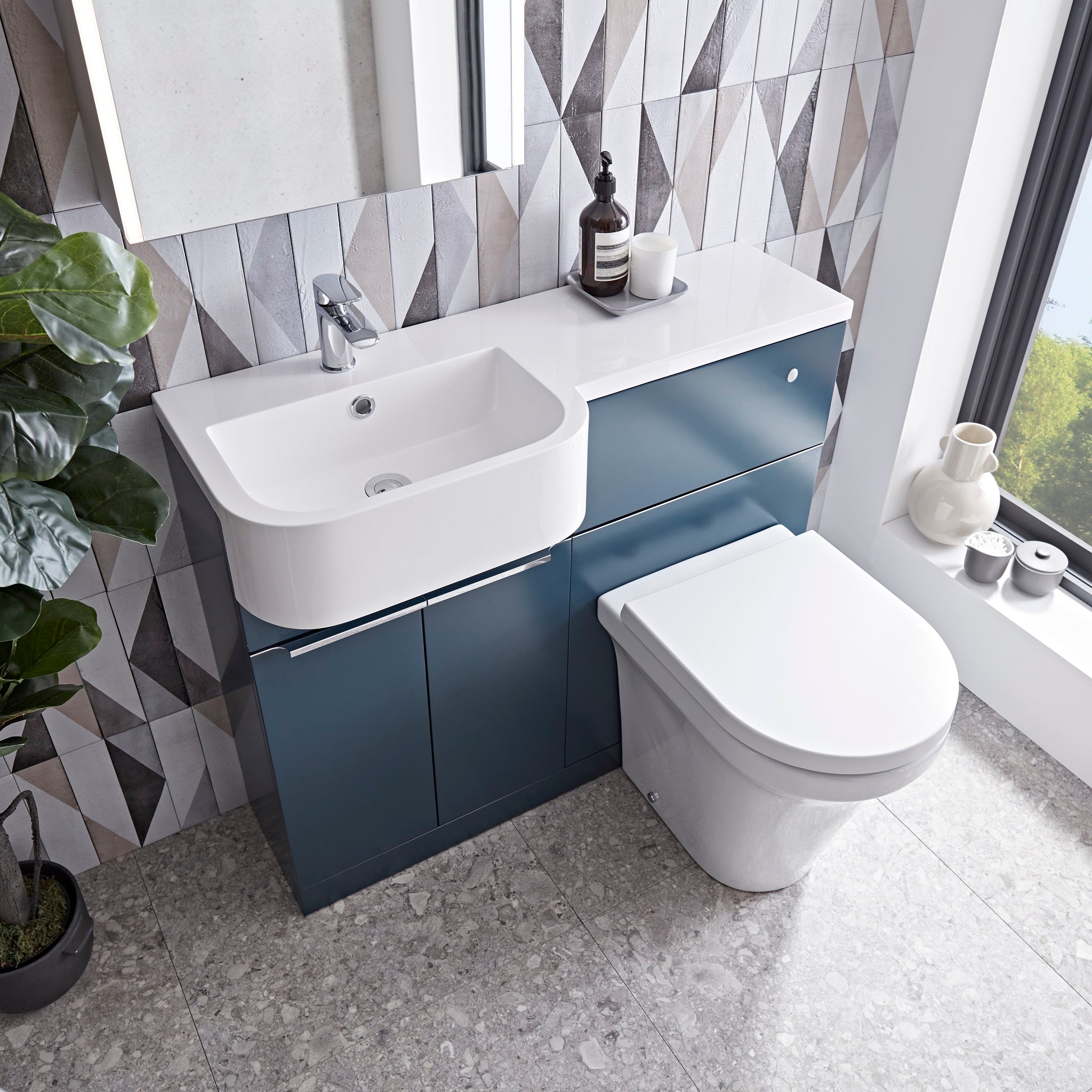 Tavistock Match 1000mm Oxford BlueTavistock Match 1000mm Combination Unit - Oxford Blue (L or R Hand) against a wooden wallpaper design underneath a mirror MATLOB