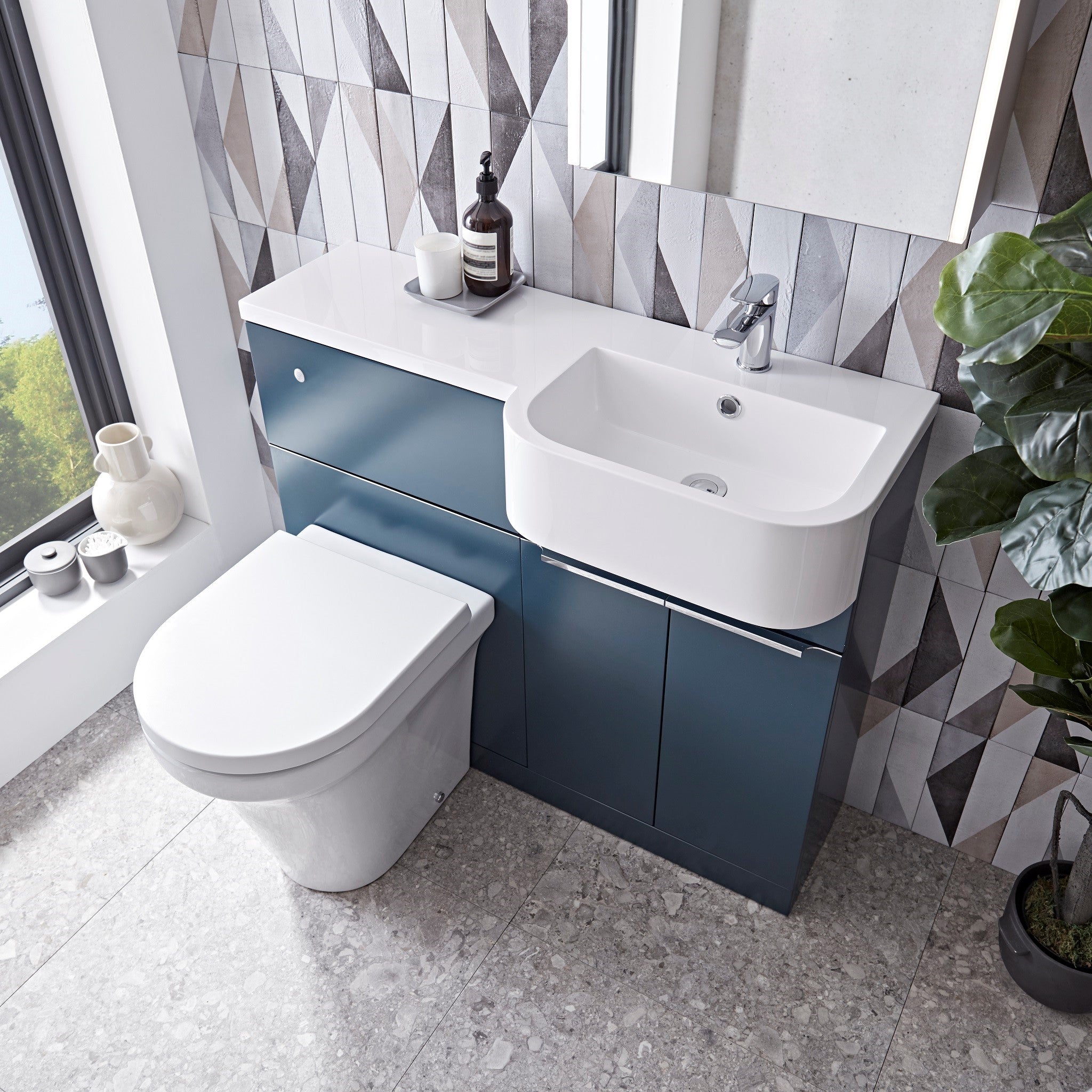 Tavistock Match 1000mm Oxford BlueTavistock Match 1000mm Combination Unit - Oxford Blue (L or R Hand) against a wooden wallpaper design underneath a mirror MATROB