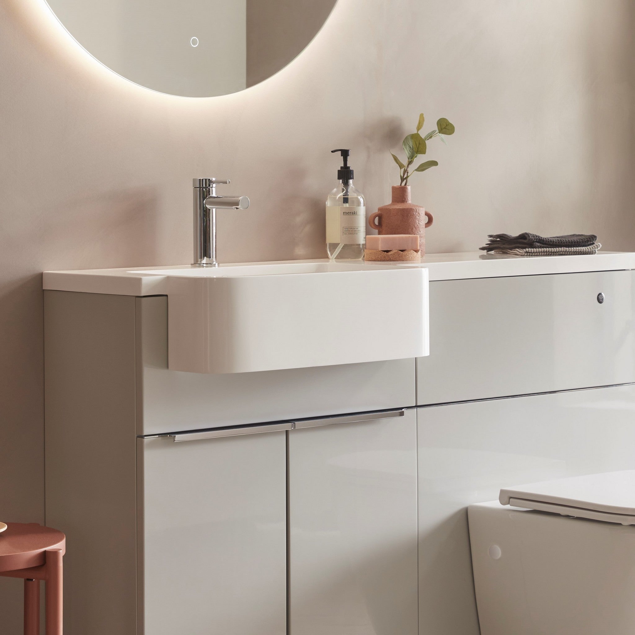 Tavistock Match 1200mm Combination Unit - Gloss Light Grey (L or R Hand) against pal painted wall underneath a light up mirror MAT12LG