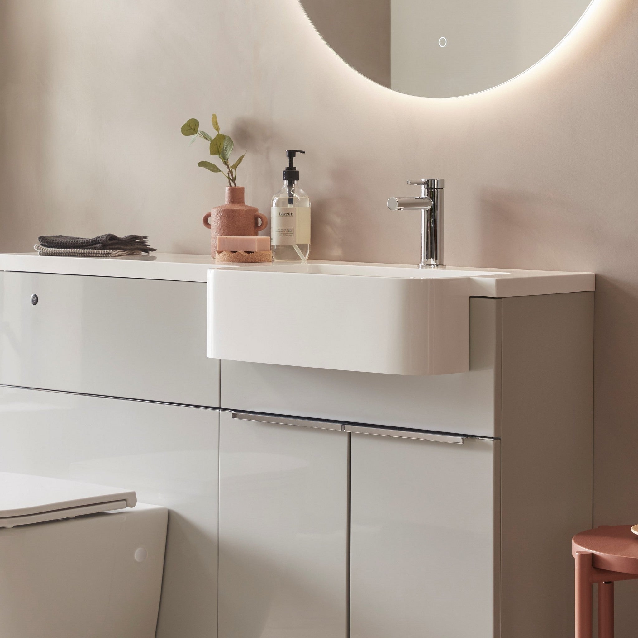 Tavistock Match 1200mm Combination Unit - Gloss Light Grey (L or R Hand) against pal painted wall underneath a light up mirror MAT12RG