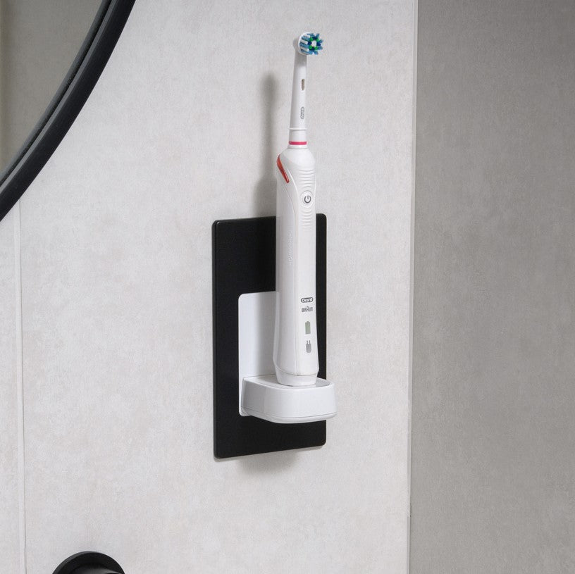 ProofVision In-Wall Electric Toothbrush Charger (Oral B & Braun) against white wood tiles next to a mirror  PV10-B-FR