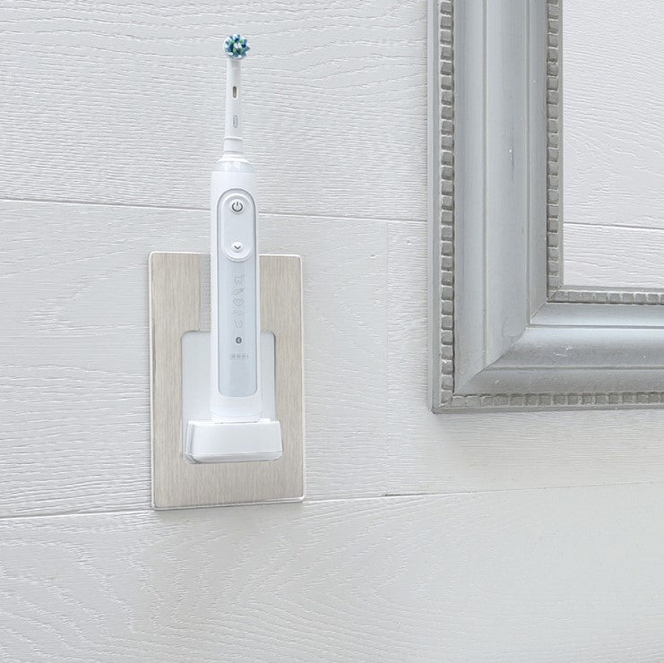 ProofVision In-Wall Electric Toothbrush Charger (Oral B & Braun) against white wood tiles next to a mirror  PV10-BS-FR