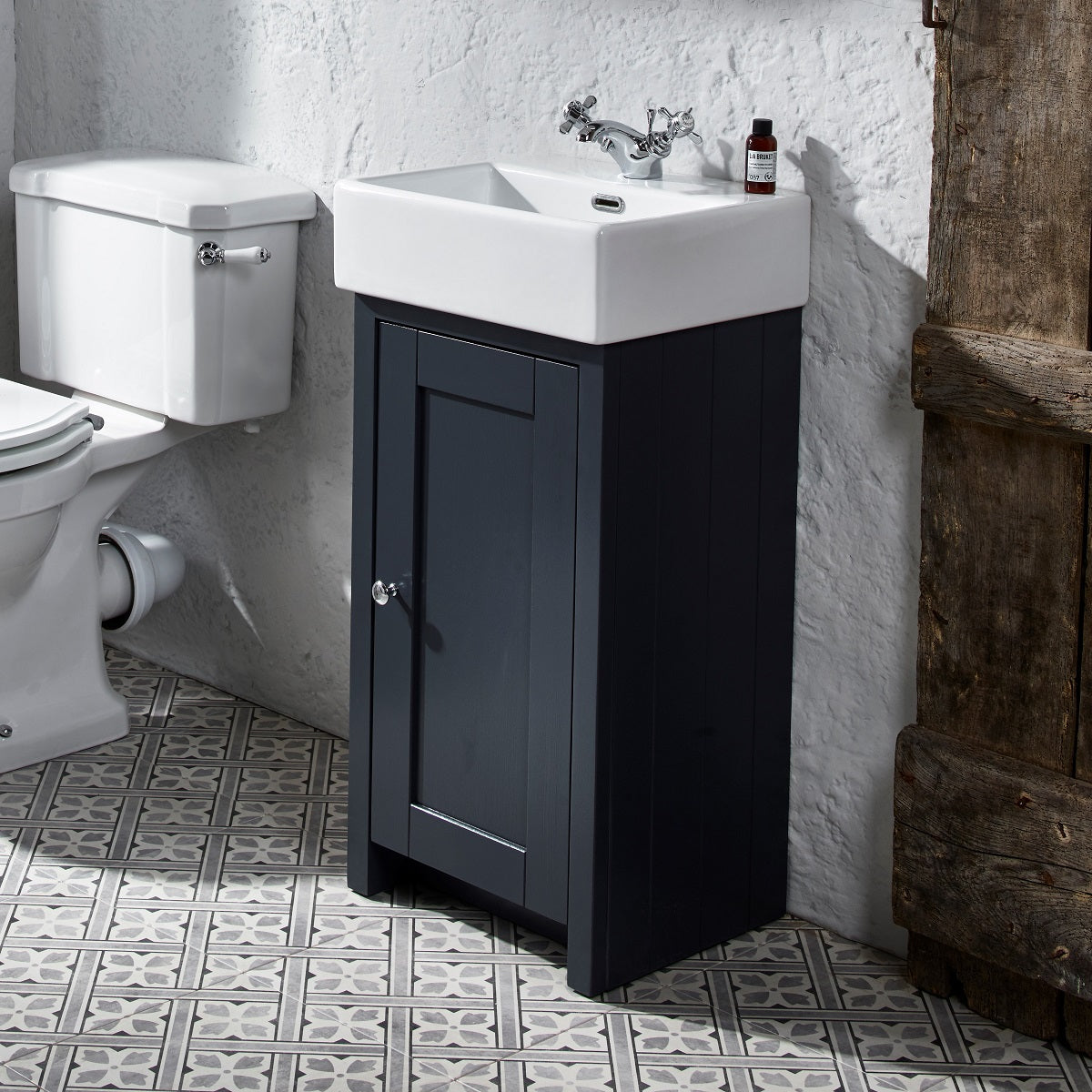 Tavistock Lansdown Cloakroom 430mm Freestanding Unit & Basin - Various Colours unit against stoned white wall with a toilet on the left side LAN400C.MB