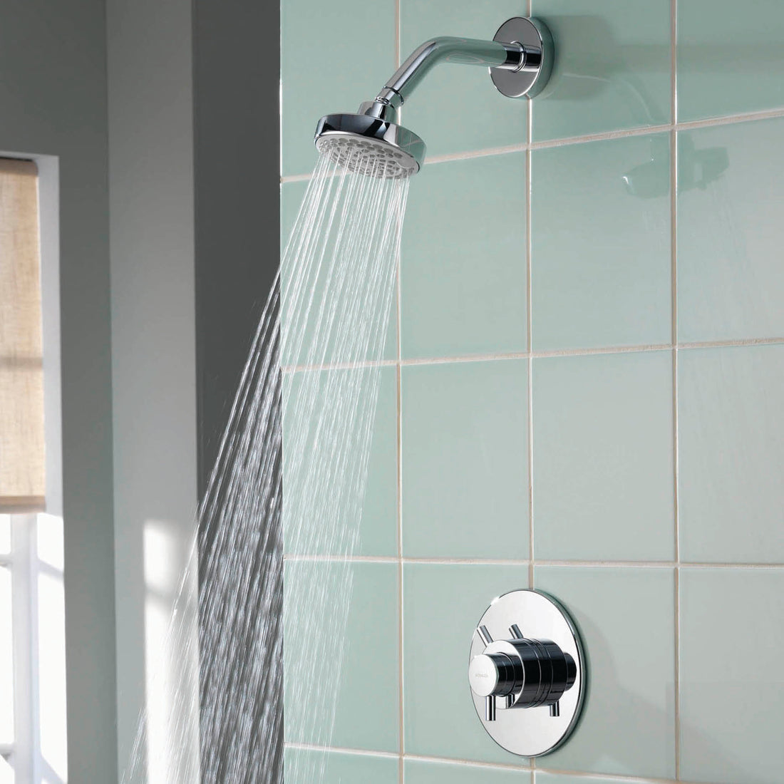 Aqualisa Aspire Mixer Shower with green wall tiles with water flowing ASP001CF