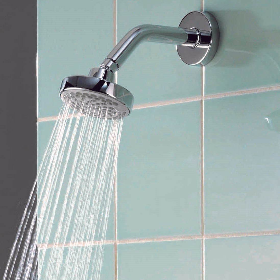 Aqualisa Aspire Mixer Shower with green wall tiles with water flowing ASP001CF