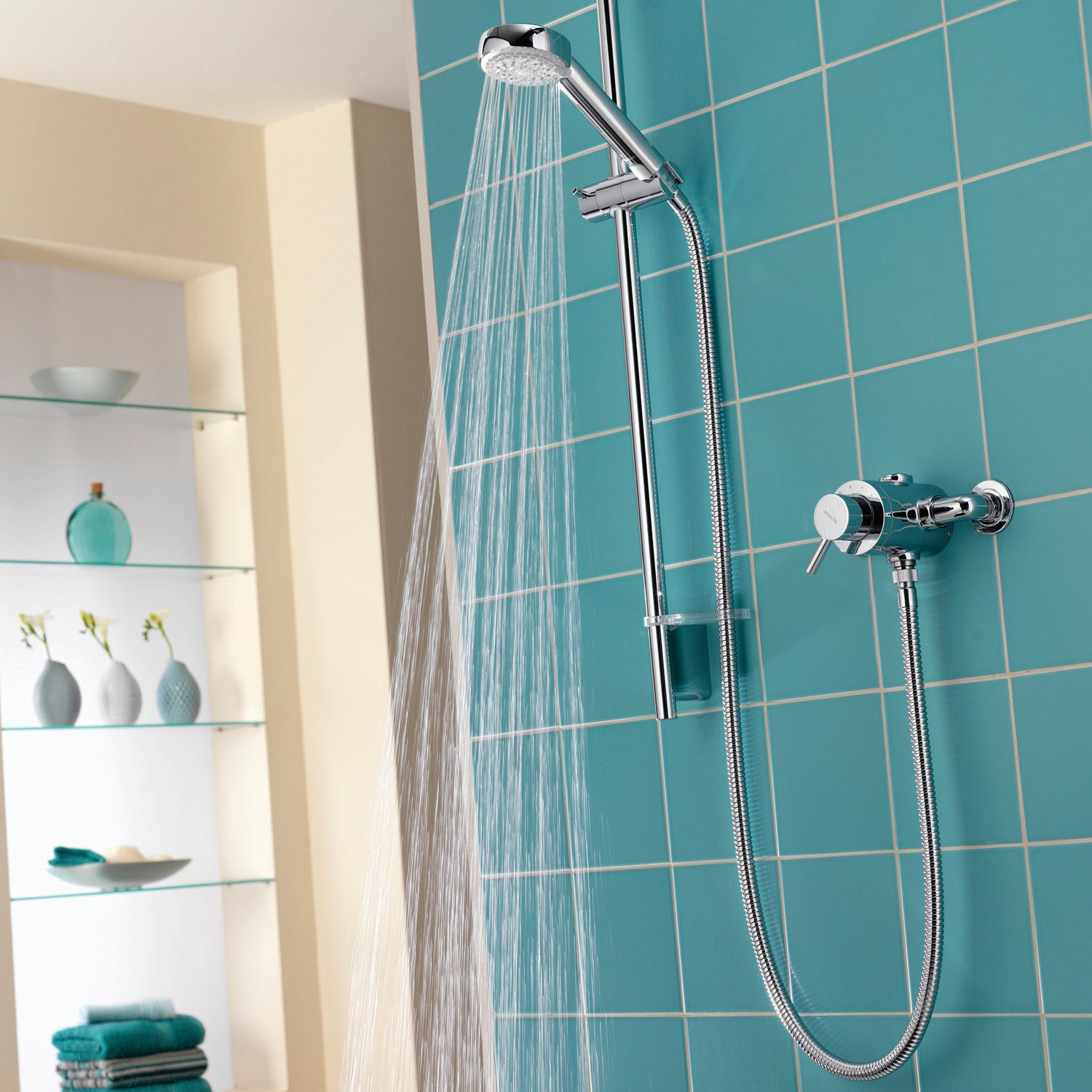 Aqualisa Siren Shower - Exposed With Adjustable Head against light blue wall water flowing SRN001EA