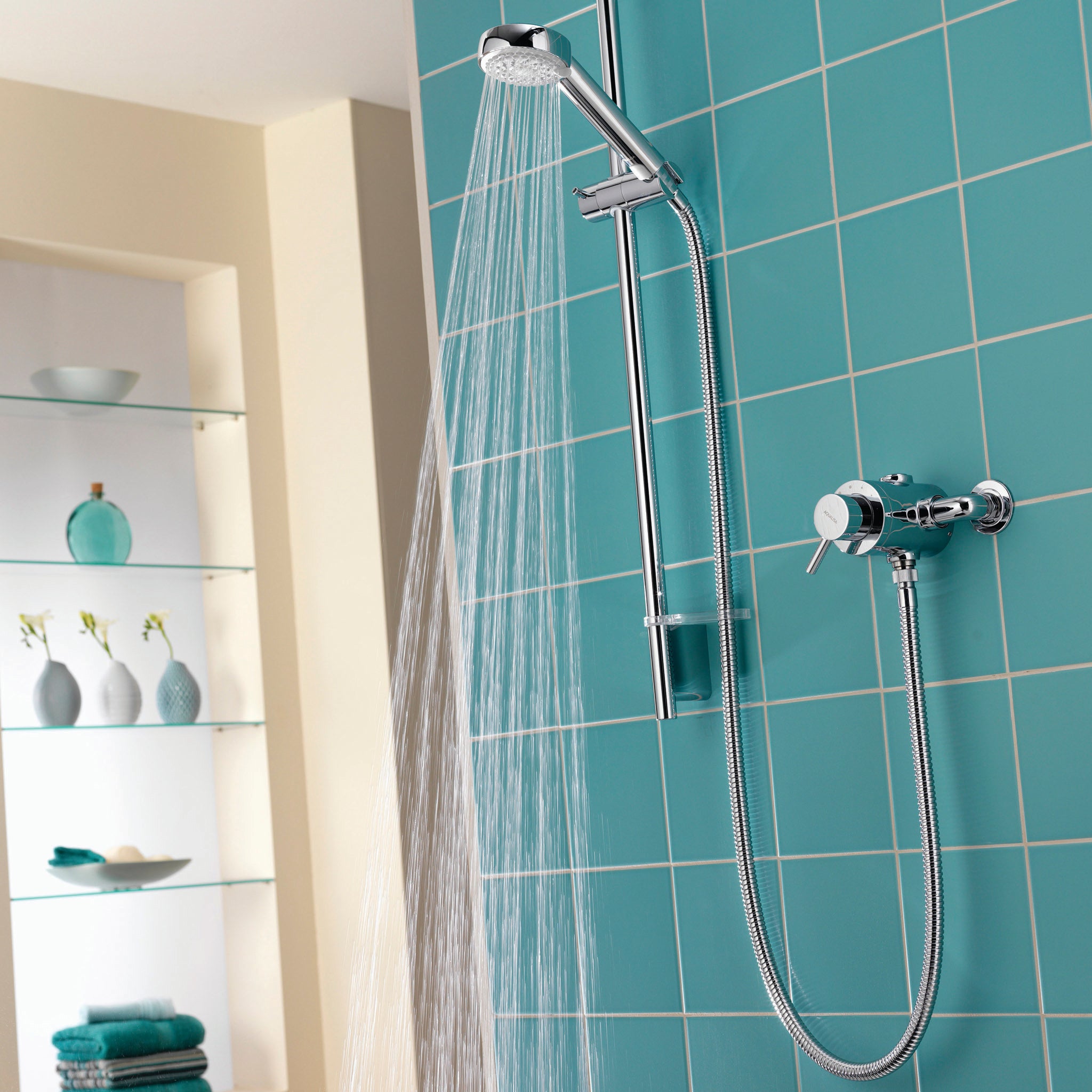 Aqualisa Siren Shower - Exposed With Adjustable Head against light blue wall water flowing SRN001EA