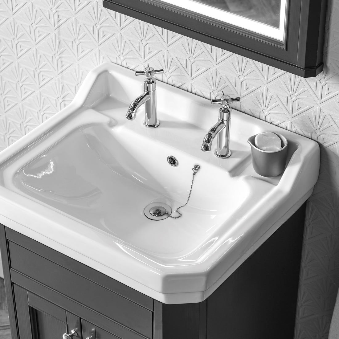 Tavistock Cheltenham Basin Taps (Pairs) - Chrome against white wallpaper underneath a black mirror TCM70