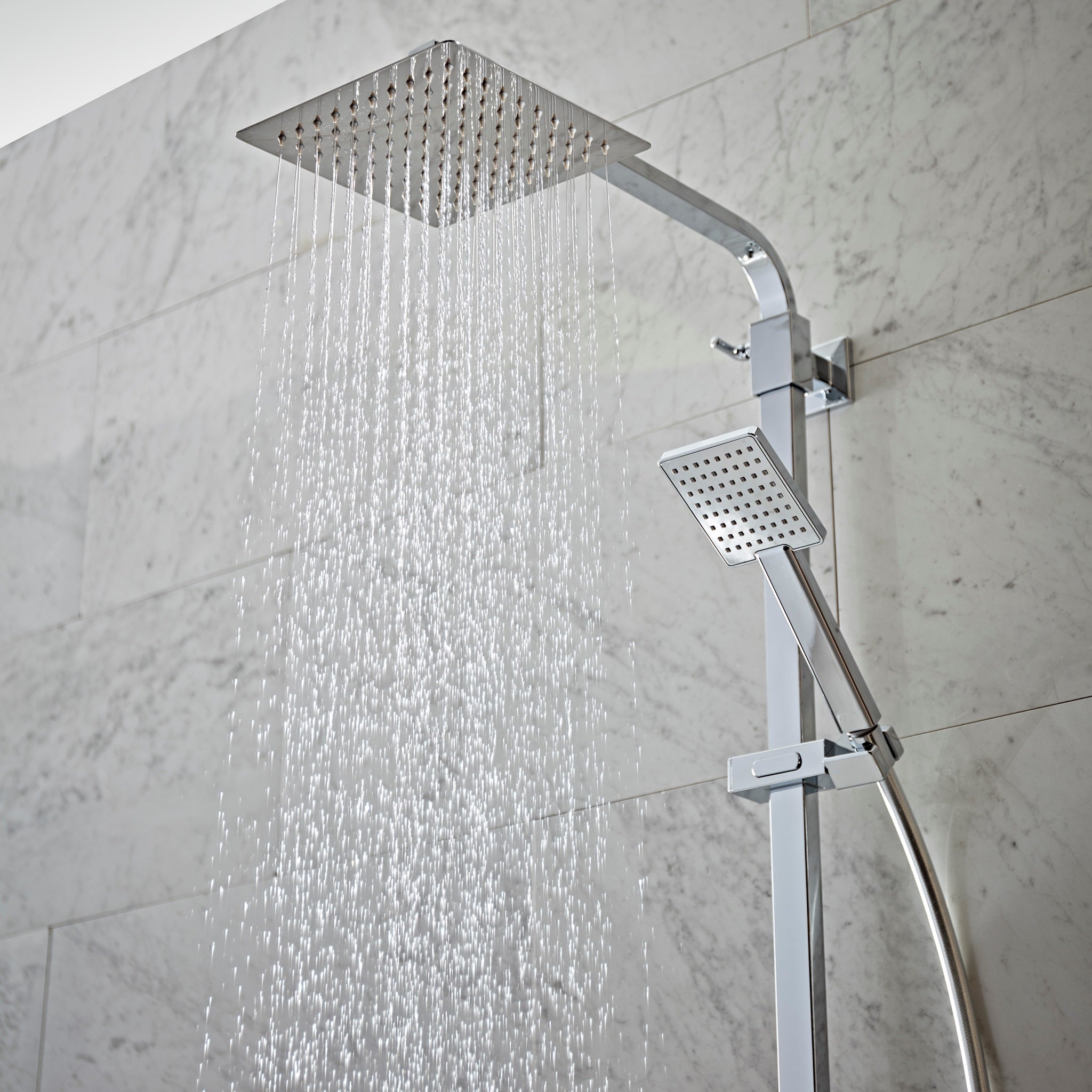 Tavistock Index Dual Function Concealed Shower System With Head And Riser Kit close up view of shower heads against light grey tiling SND1610