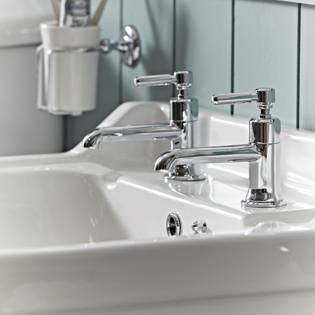 Tavistock Marston Deck Mounted Bath Filler - Chrome close up view highlighting the basins with a blurred background TMS32