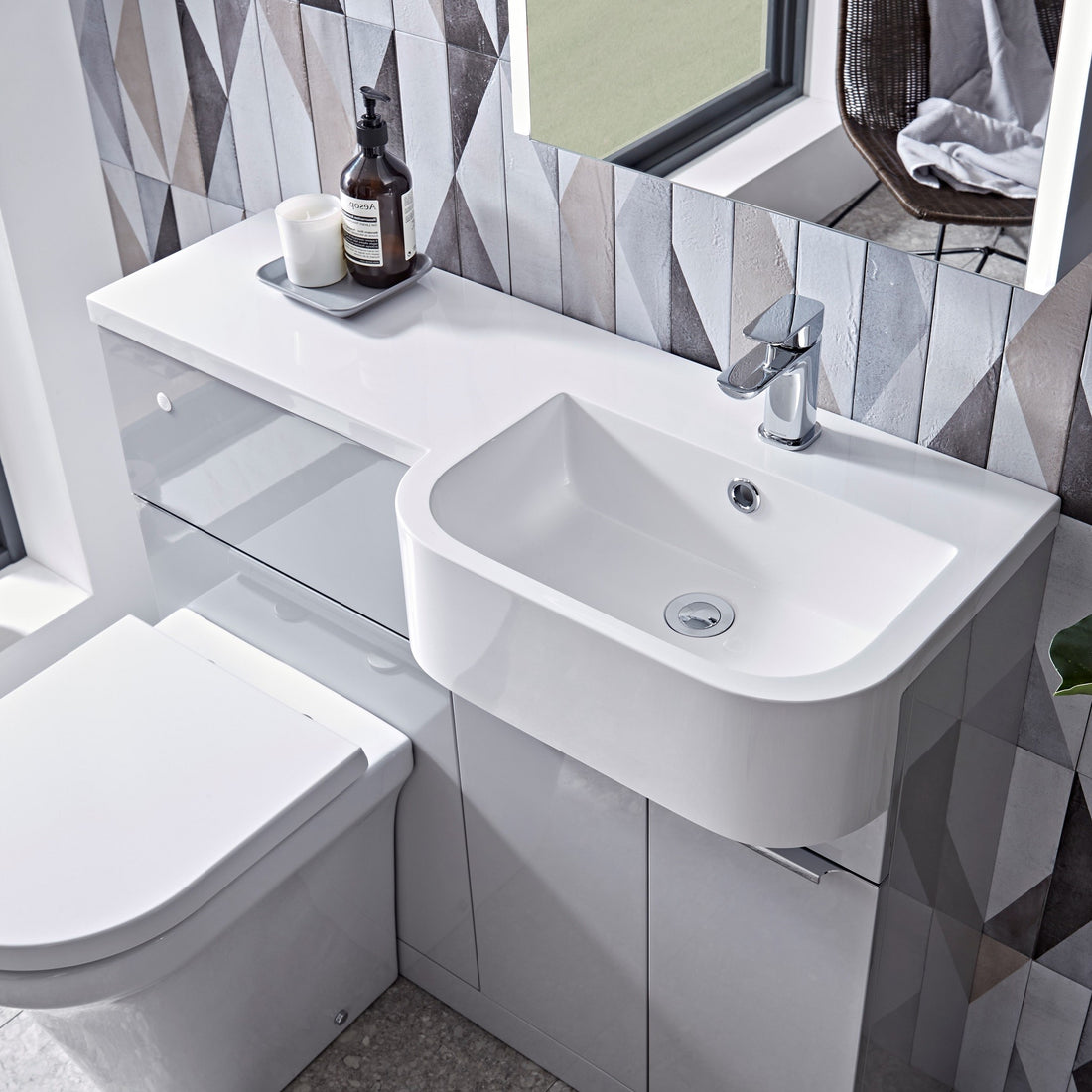 Tavistock Match 1000mm Combination Unit - Gloss Light Grey (L or R Hand) unit against wooden wallpaper design underneath a mirror MATRG