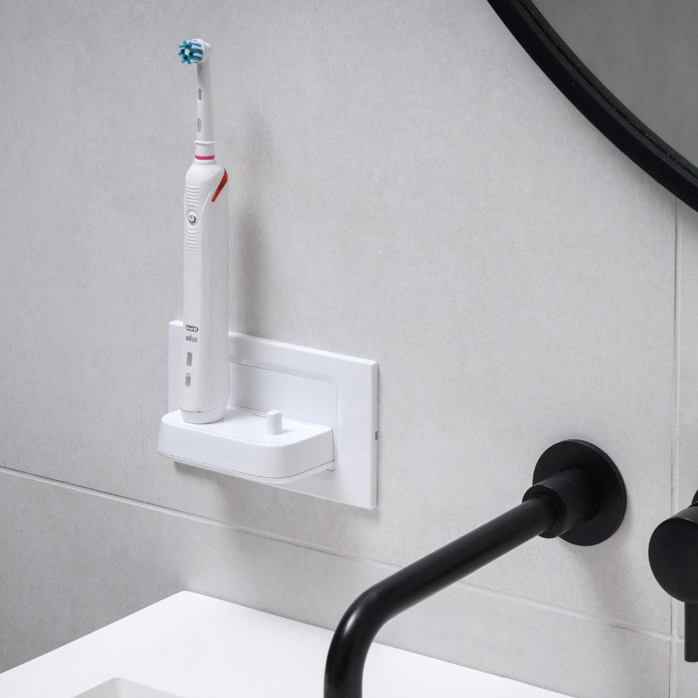 ProofVision In-Wall Dual Electric Toothbrush Charger against white tiles above a basin in white PV11P
