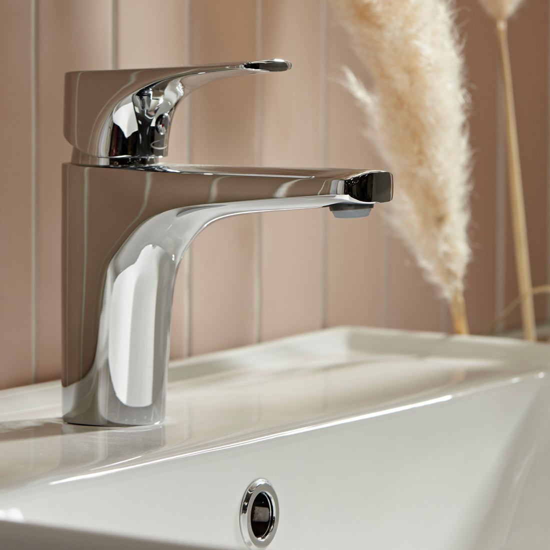 Tavistock Strike Basin Mixer With Click Waste - Chrome close up view of basin background blurred out TSE11