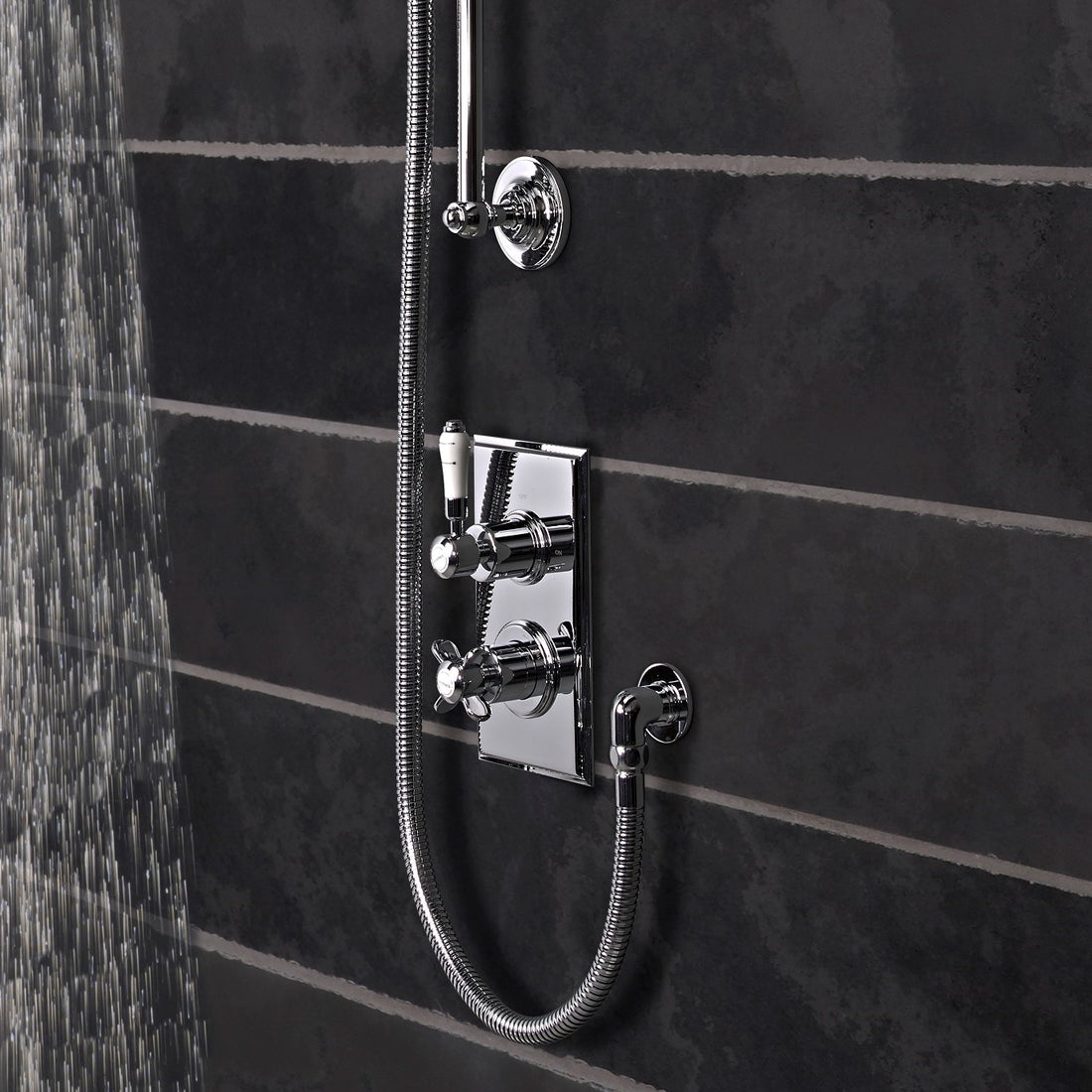 Tavistock Varsity Concealed Dual Function Diverter System - Chrome close up view of the controls of the shower in front of the grey dark tiling SVA1615