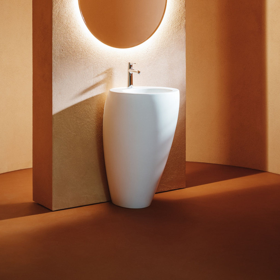 Laufen Ilbagnoalessi white Freestanding Washbasin against orange painted wall