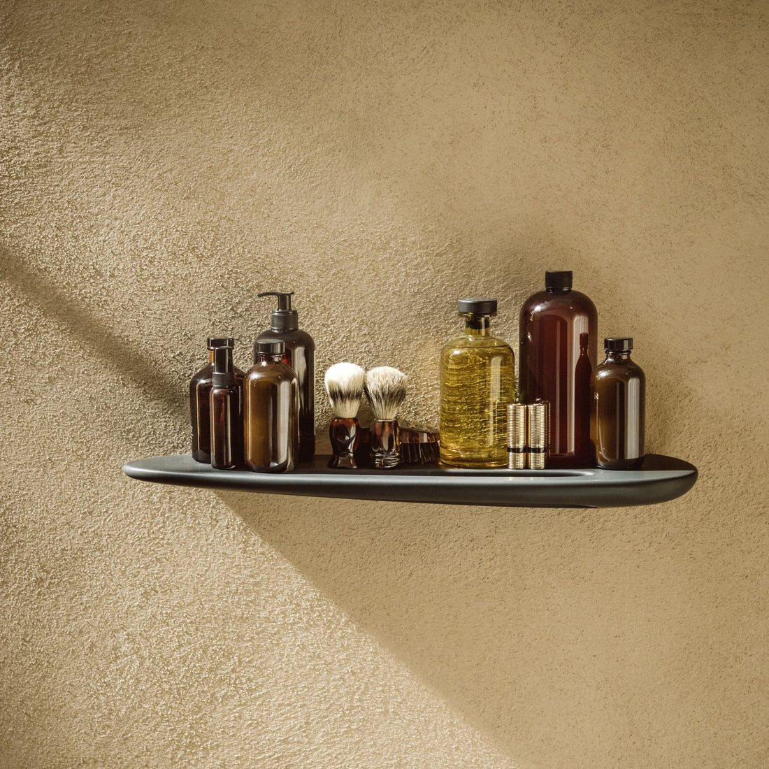Laufen Ilbagno Alessi One shelf with integrated towel holder matt black against yellow painted wall.
