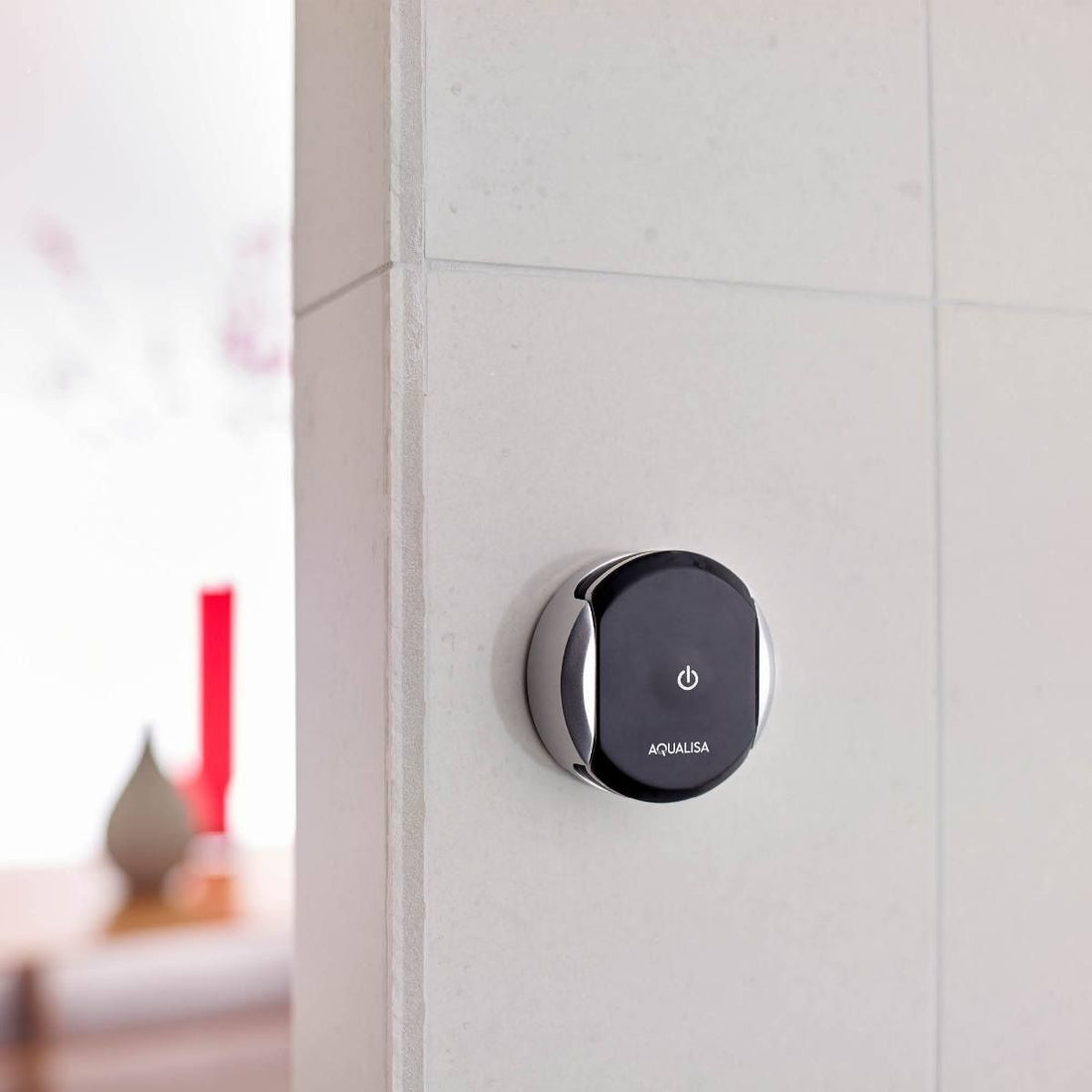 Aqualisa Quartz Touch Wireless Remote against white tiled wall WR.BL.CP.20