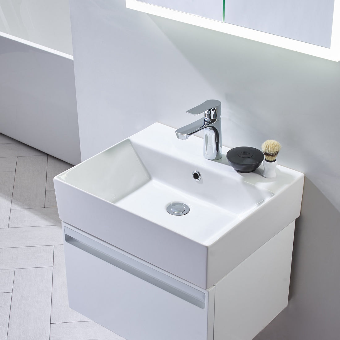 Tavistock Forum 500mm Wall Mounted Unit & Basin - Various Colours against white wall underneath a mirror in white FR50WW