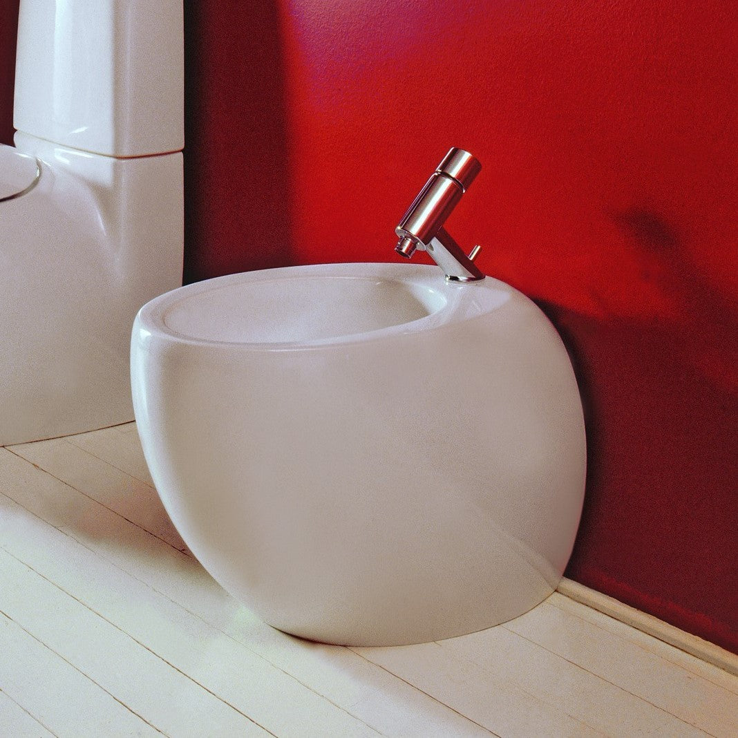 Laufen Ilbagnoalessi One white floorstanding bidet against red painted wall.
