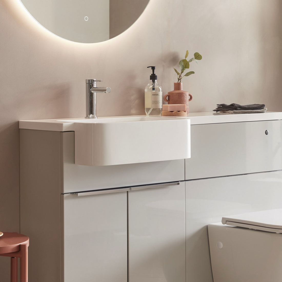 Tavistock Match 1200mm Combination Unit - Gloss Light Grey (L or R Hand) against pal painted wall underneath a light up mirror MAT12LG