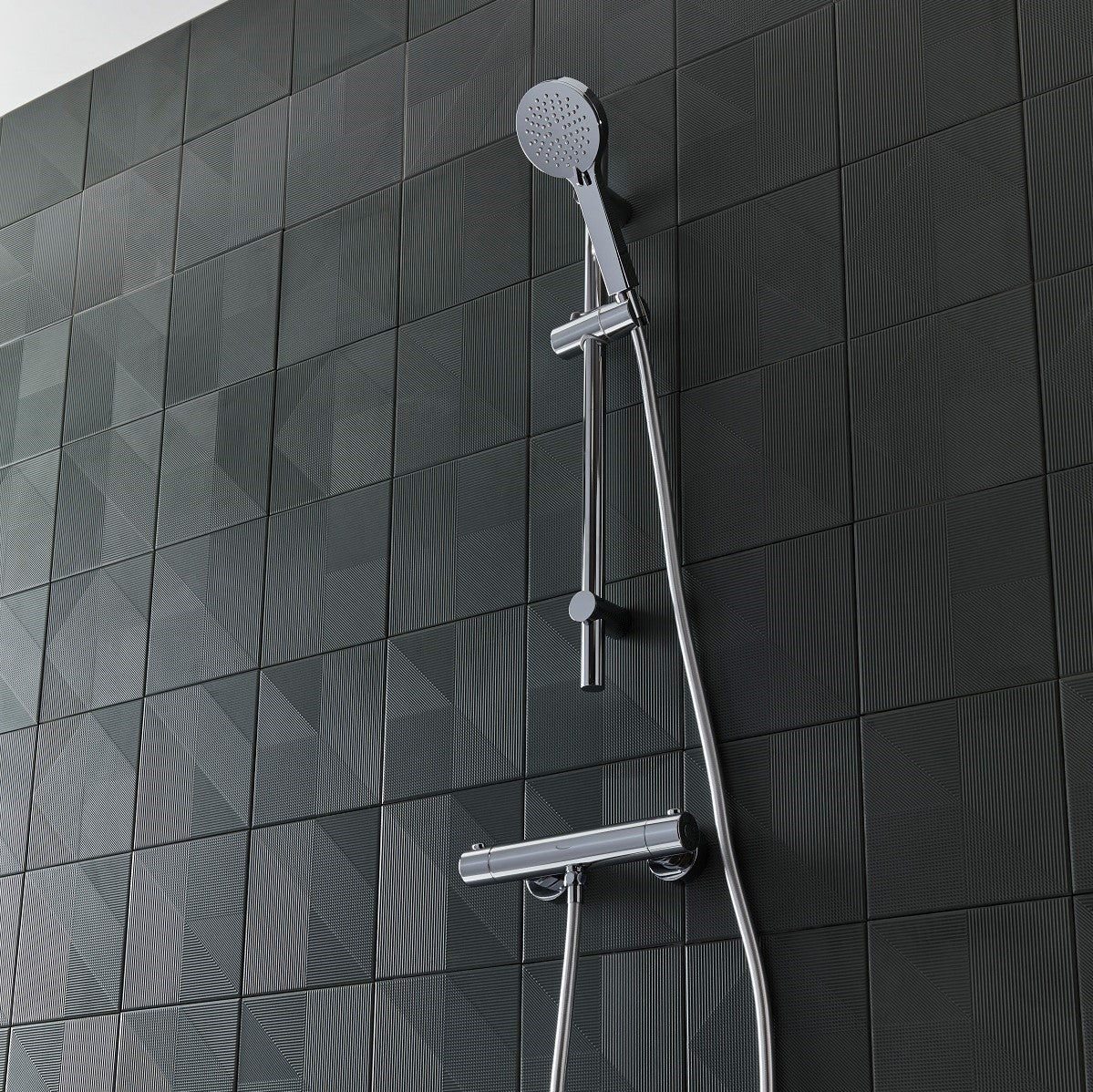 Tavistock Quantum Exposed Cool Touch Outlet Shower System with Slide Rail Kit against a tiled design in grey SQT2416