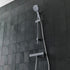 Tavistock Quantum Exposed Cool Touch Outlet Shower System with Slide Rail Kit against a tiled design in grey SQT2416
