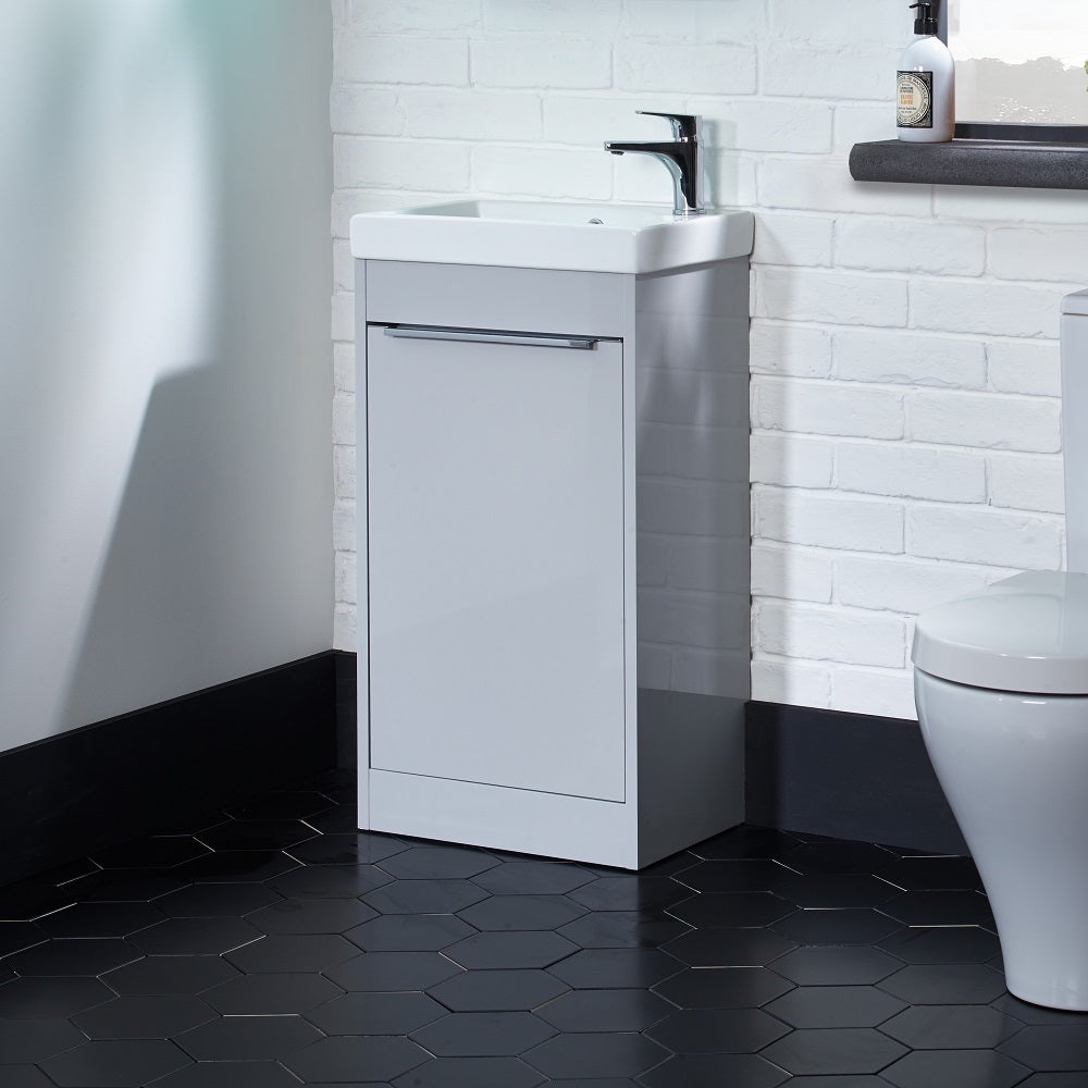 Tavistock Sequence 460mm Cloakroom Unit &amp; Basin - Various Colours against stone wall in white sitting on black tiled flooring SQ450FG